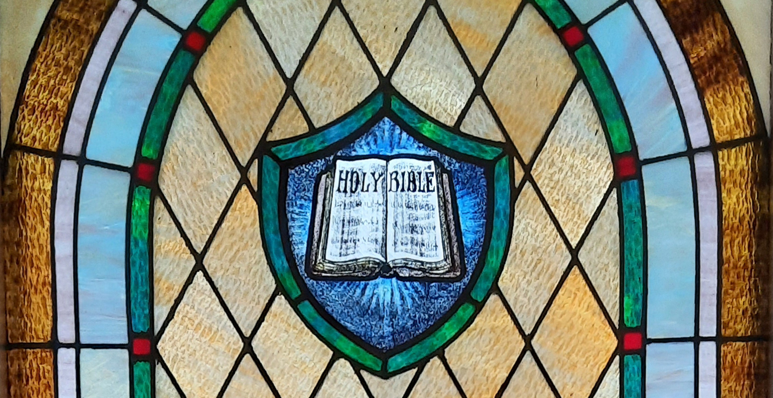 Stained glass window depicting an open Bible.